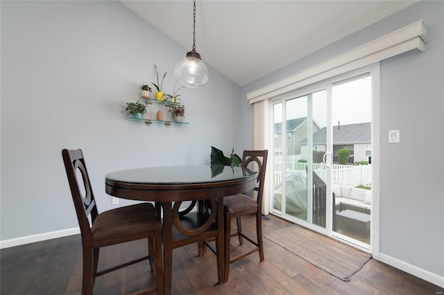 dining space featuring baseboards, vaulted ceiling, and dark wood-style flooring