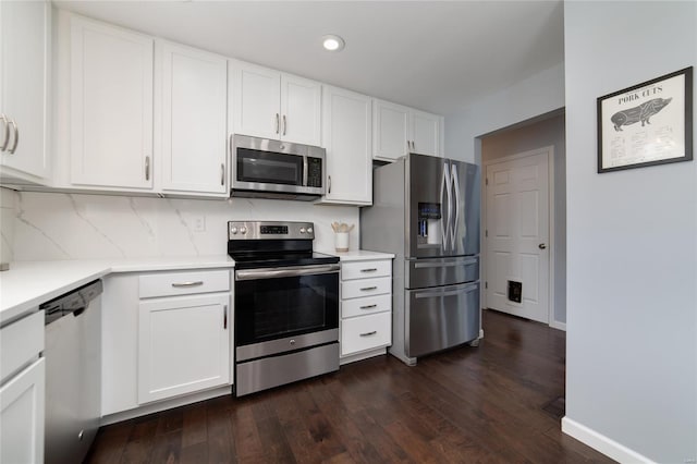 kitchen with light countertops, white cabinetry, appliances with stainless steel finishes, and dark wood-style floors