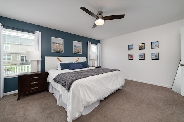 bedroom with baseboards, ceiling fan, and light carpet