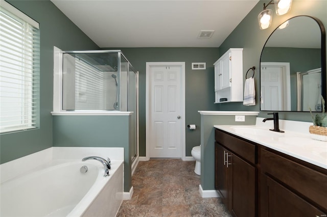 full bathroom with a stall shower, visible vents, a bath, and vanity