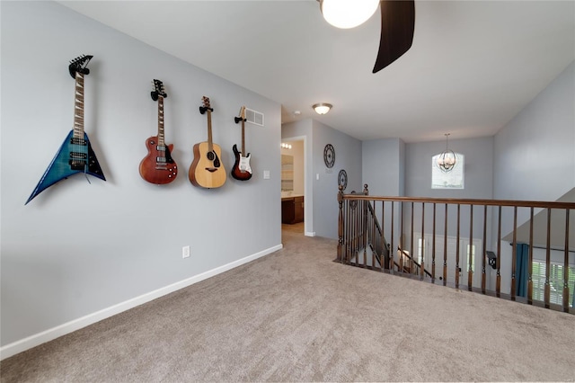 hall featuring carpet flooring, an inviting chandelier, baseboards, an upstairs landing, and visible vents