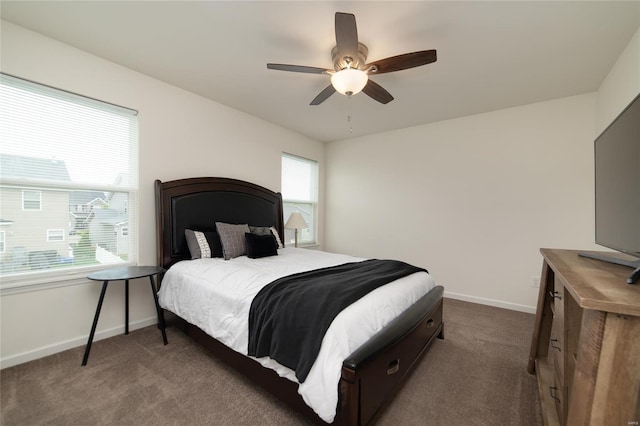 bedroom with baseboards, a ceiling fan, and dark carpet