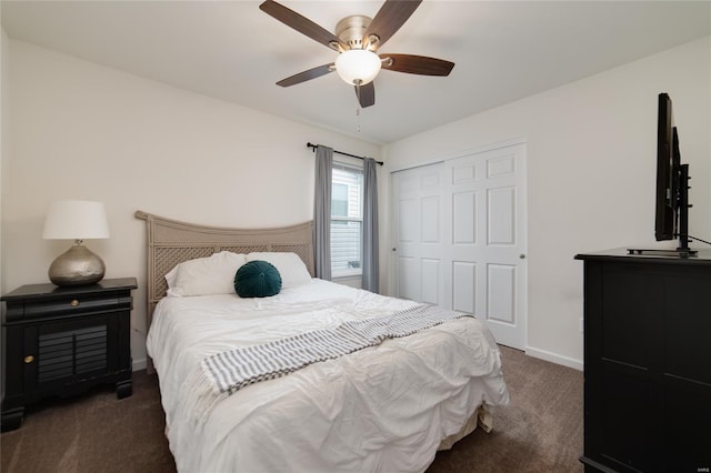 bedroom with carpet floors, a ceiling fan, baseboards, and a closet