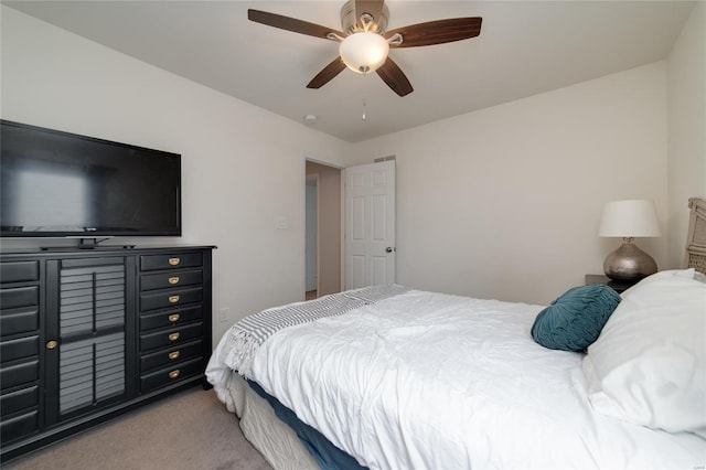 bedroom with a ceiling fan and carpet