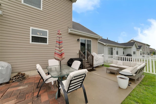 view of patio / terrace featuring fence, an outdoor hangout area, and outdoor dining space