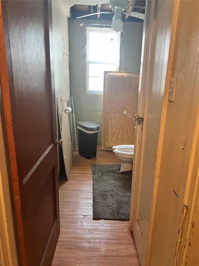 bathroom with toilet and hardwood / wood-style flooring