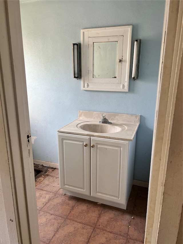 bathroom featuring baseboards and vanity