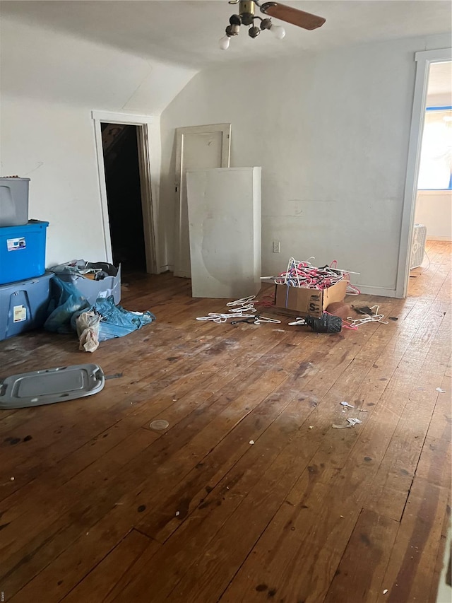 additional living space with wood-type flooring, a ceiling fan, and vaulted ceiling