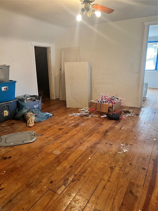 empty room featuring a ceiling fan, hardwood / wood-style flooring, and lofted ceiling