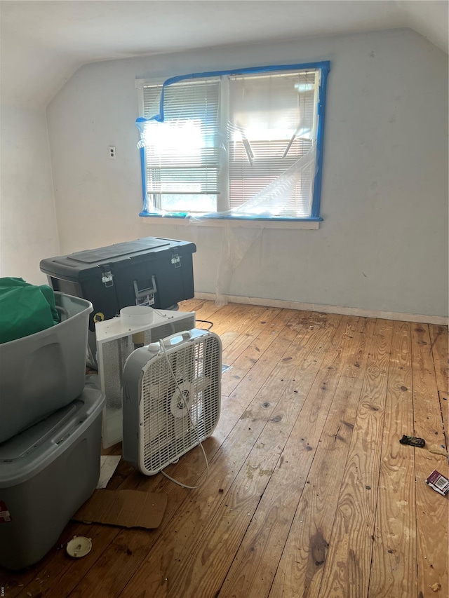 additional living space with wood-type flooring and lofted ceiling