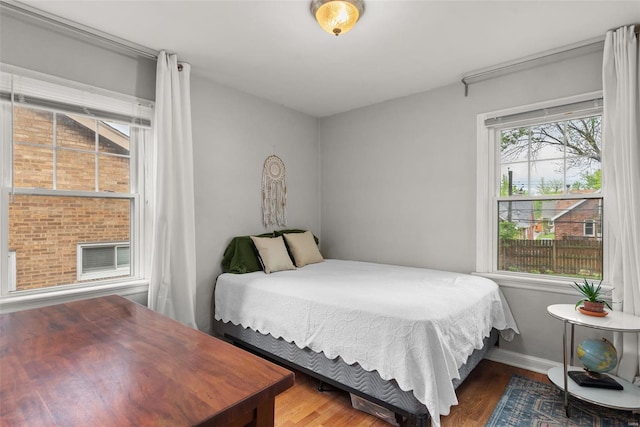 bedroom featuring baseboards and wood finished floors