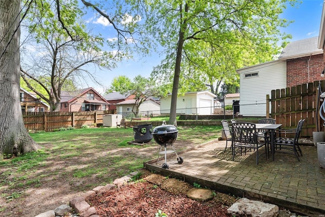 view of yard with a fenced backyard, outdoor dining area, a patio area, and a residential view