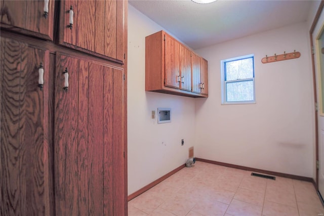 laundry room featuring cabinet space, washer hookup, electric dryer hookup, visible vents, and baseboards