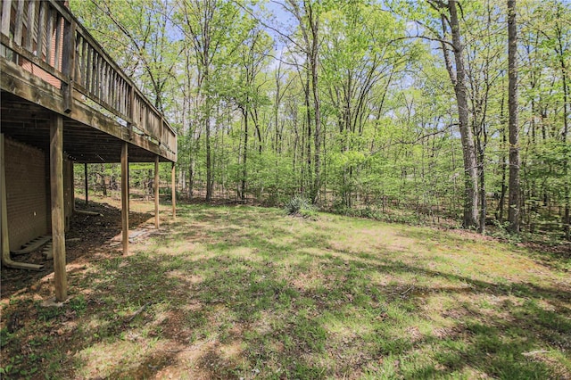 view of yard with a deck and a forest view