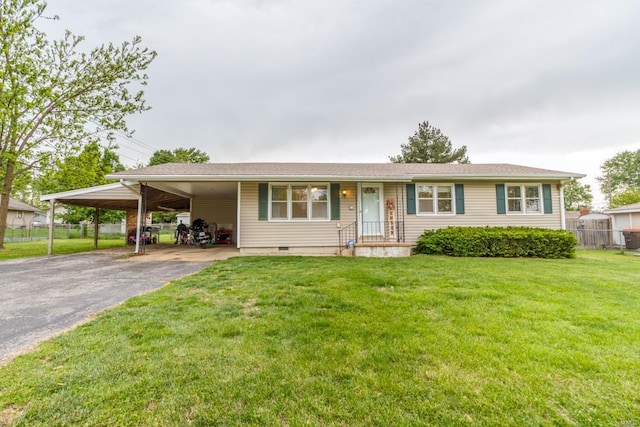 single story home featuring a carport, fence, aphalt driveway, and a front yard