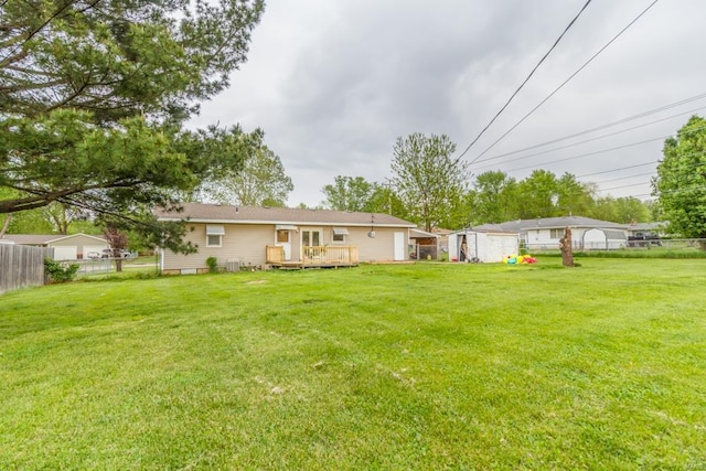 view of yard with fence and a deck
