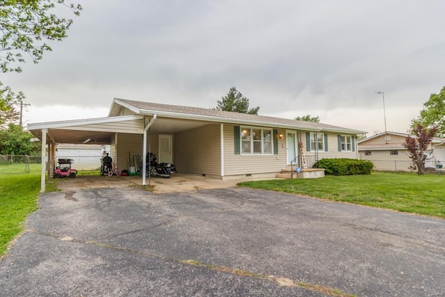 view of front of home featuring aphalt driveway, an attached carport, crawl space, fence, and a front lawn