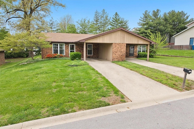 single story home featuring driveway, an attached carport, a front yard, fence, and brick siding