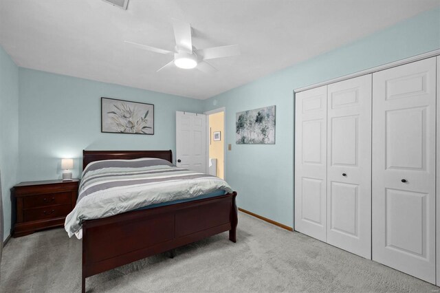 carpeted bedroom with a closet, a ceiling fan, and baseboards