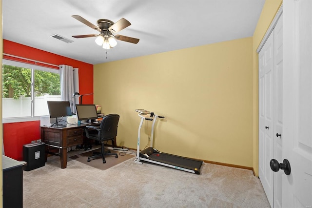 carpeted office with a ceiling fan, visible vents, and baseboards