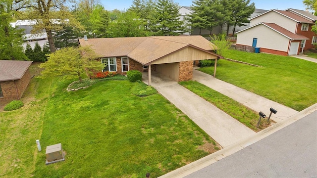 view of front of house with concrete driveway, an attached carport, a front lawn, and stone siding