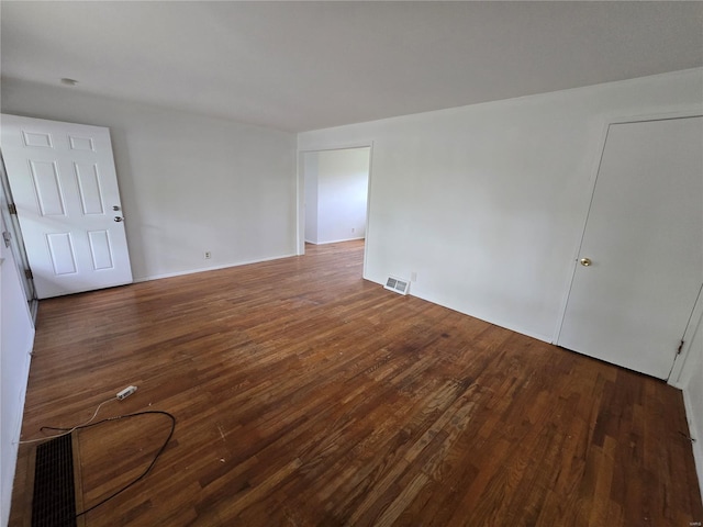 spare room with visible vents and wood finished floors