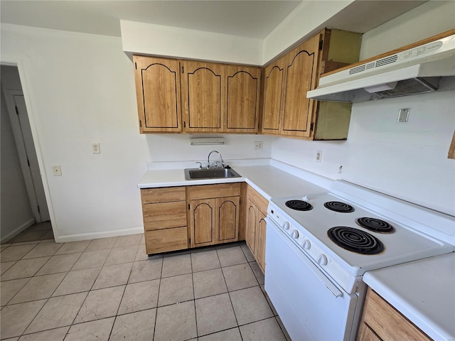 kitchen with a sink, under cabinet range hood, white range with electric stovetop, and light countertops