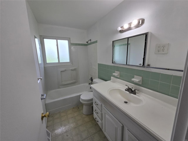 bathroom with vanity, toilet, tile patterned floors, shower / bath combination, and tile walls