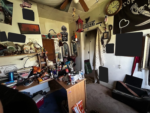 interior space featuring lofted ceiling, a ceiling fan, and carpet flooring