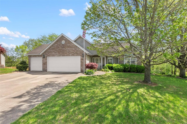 view of front facade with concrete driveway, a front yard, an attached garage, and brick siding