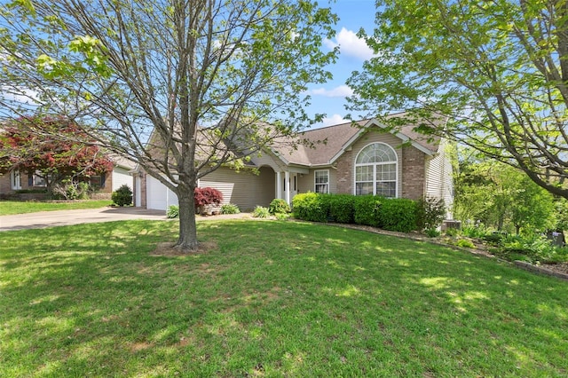 view of front of home with a front yard, concrete driveway, and an attached garage