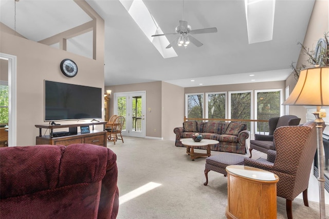 living area featuring ceiling fan, recessed lighting, carpet, high vaulted ceiling, and a skylight