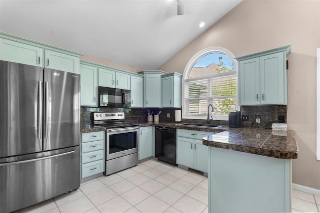 kitchen featuring black appliances, a sink, tile counters, and backsplash