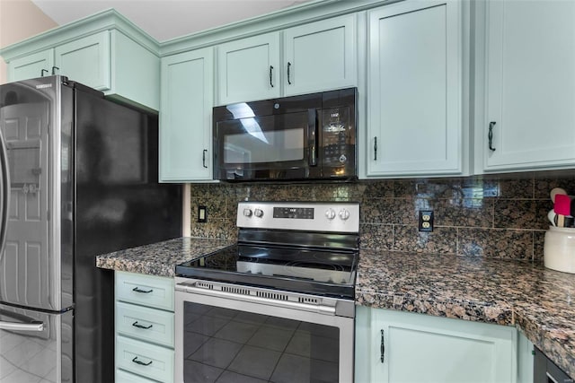 kitchen with dark stone countertops, stainless steel appliances, and decorative backsplash