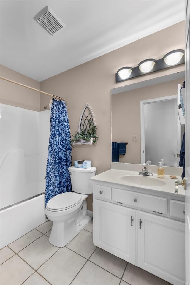bathroom with visible vents, shower / bath combo with shower curtain, toilet, vanity, and tile patterned flooring