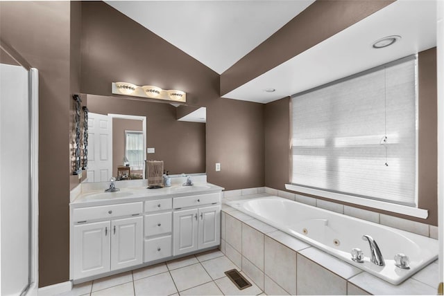 full bath featuring lofted ceiling, visible vents, a tub with jets, and a sink