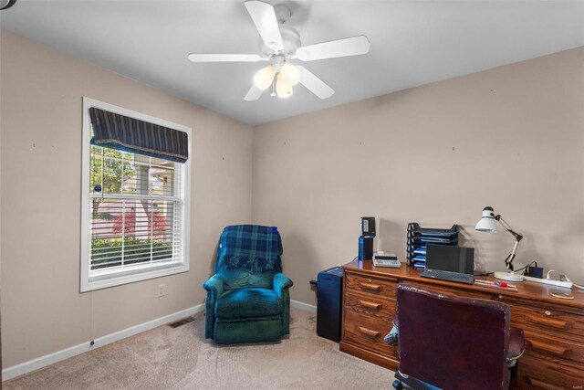 carpeted home office featuring a ceiling fan, visible vents, and baseboards