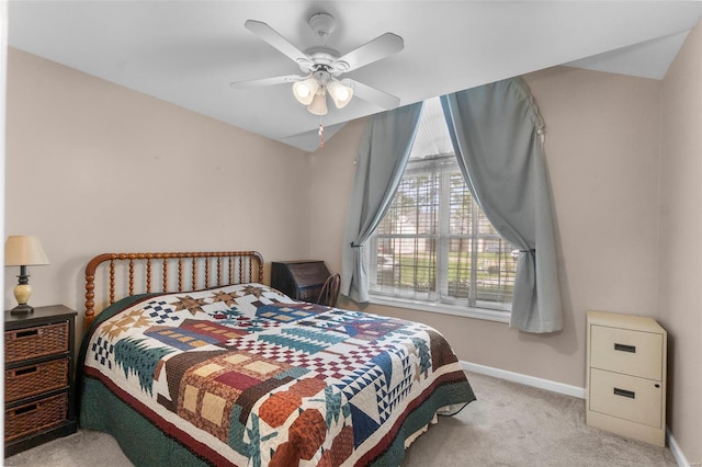 carpeted bedroom with baseboards and ceiling fan