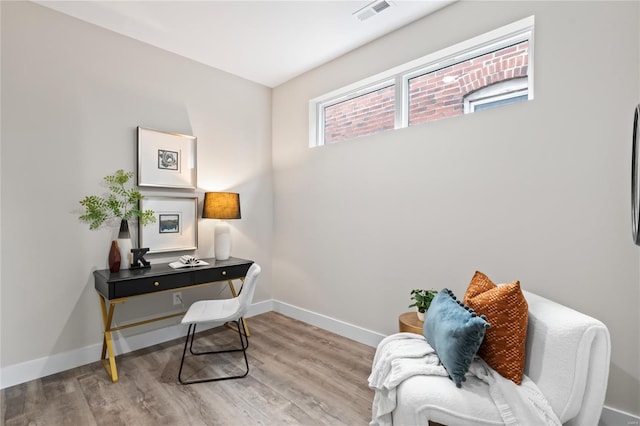 office area featuring baseboards, wood finished floors, and visible vents