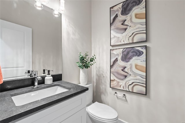 half bathroom featuring toilet and vanity