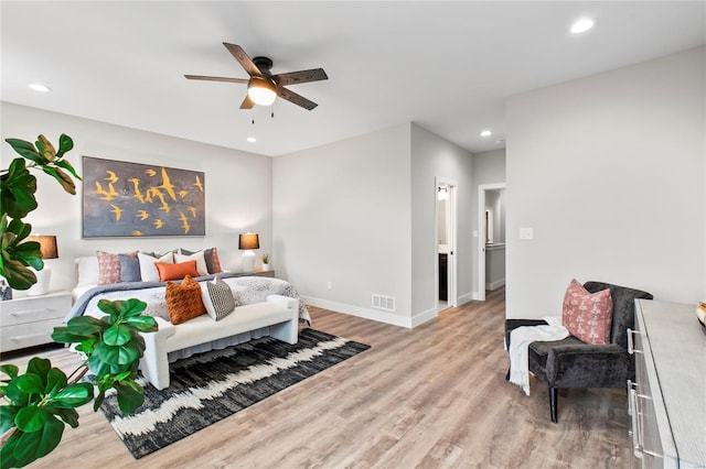 bedroom with baseboards, recessed lighting, wood finished floors, and visible vents
