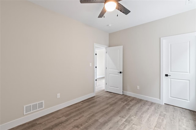 unfurnished bedroom featuring visible vents, light wood-style flooring, ceiling fan, and baseboards