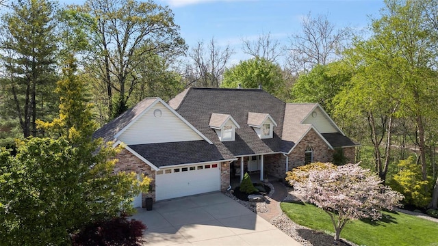 view of front of property with roof with shingles, brick siding, an attached garage, driveway, and a porch