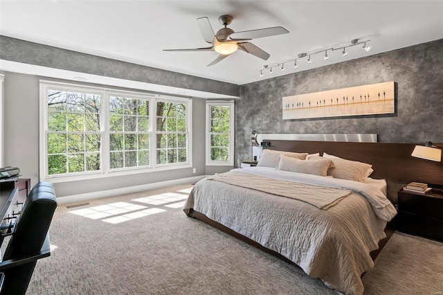 bedroom featuring visible vents, a ceiling fan, and carpet