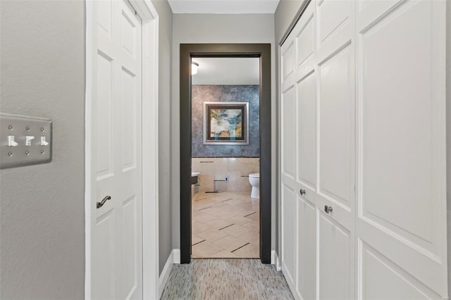 hall featuring baseboards