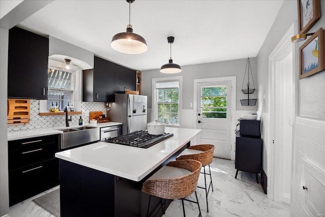 kitchen with dark cabinets, appliances with stainless steel finishes, and marble finish floor