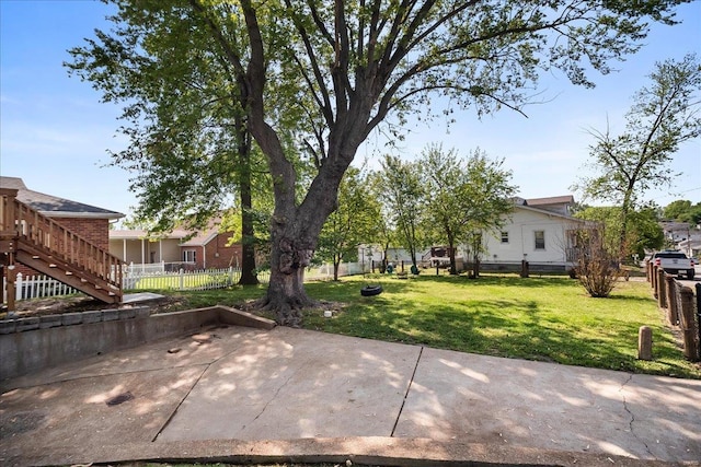 view of yard featuring stairs, a patio area, and fence