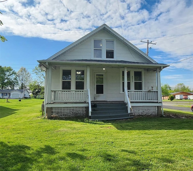 bungalow-style home with covered porch and a front yard
