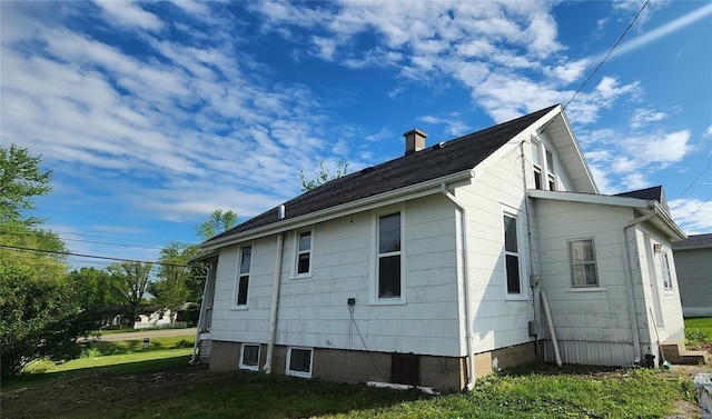 view of property exterior featuring a chimney