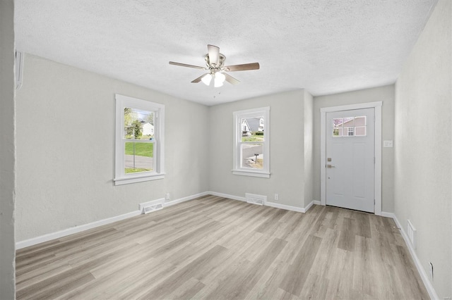 entryway with a healthy amount of sunlight, visible vents, and light wood-type flooring